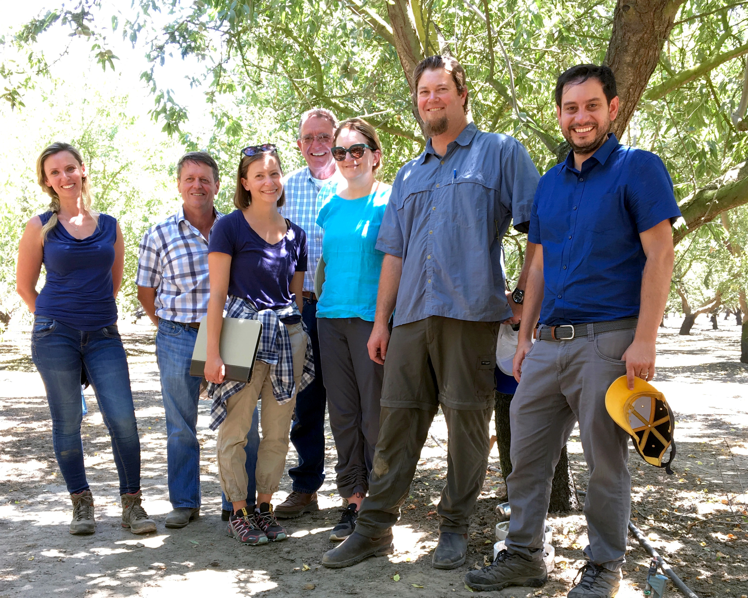 Collaborators gather to study nitrogen efficiency in a Modesto almond orchard, including, from left, postdoctoral researcher Hanna Ouaknin; Professor Patrick Brown; Ph.D. student Jessica Rudnick; grower Art Bowman; Professor Gail Taylor; Ph.D. student Patrick Nichols; and Sebastian Saa Silver, UC Davis alum and agricultural researcher with the California Almond Board.