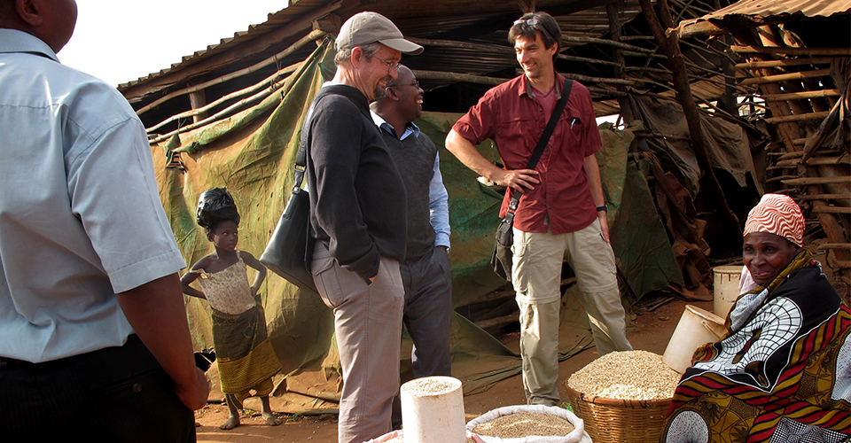 Principal investigators Michael Carter (third from left) and Stephen Boucher (second from right) visit a local market in Mozambique with their local research partners. (Jonathan Malacarne/AMA Innovation Lab)