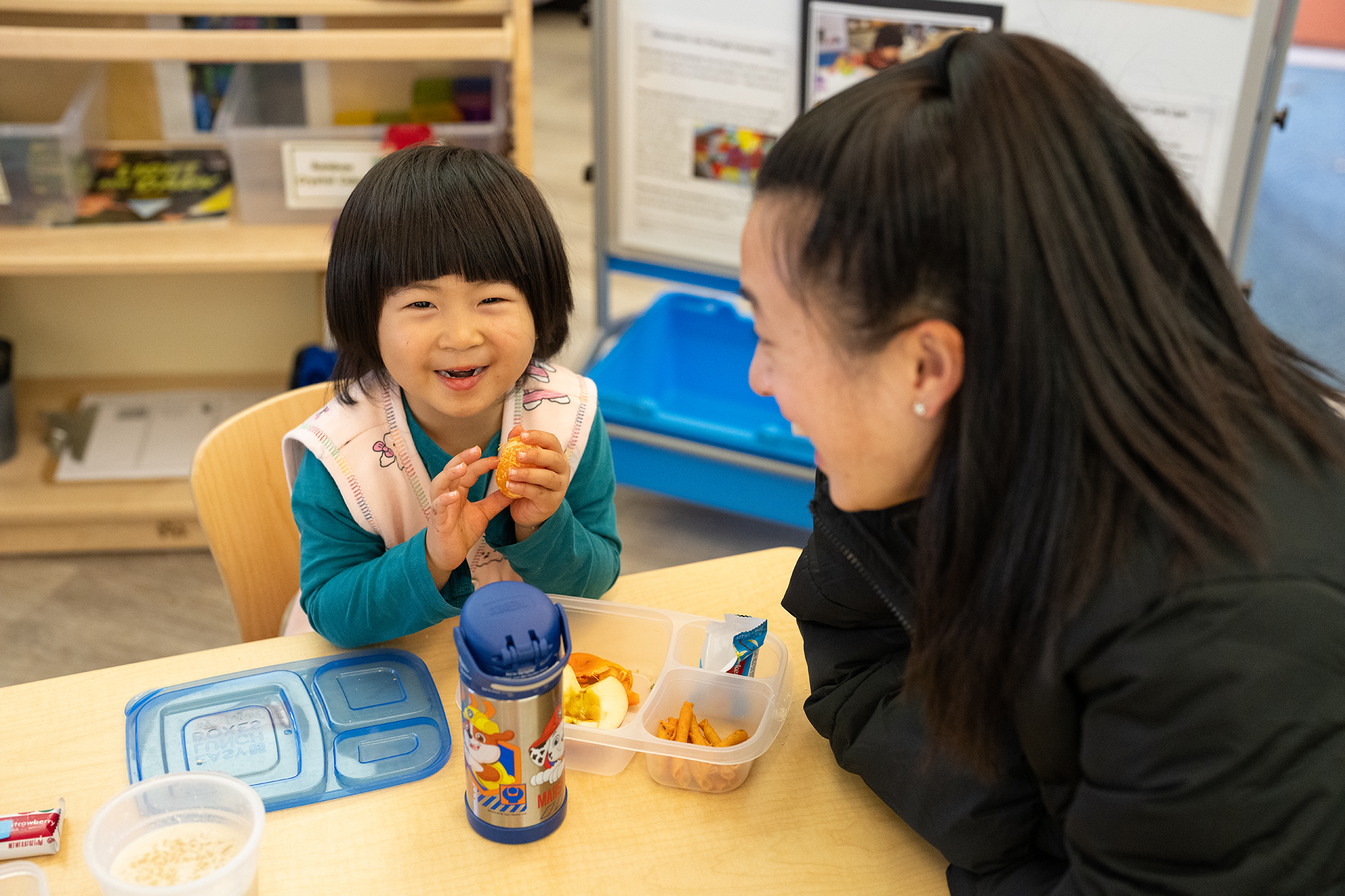 Classroom intern Katie Quan and a child having a snack at the Early Childhood Lab School. Photo by: Jael Mackendorf, UC Davis.
