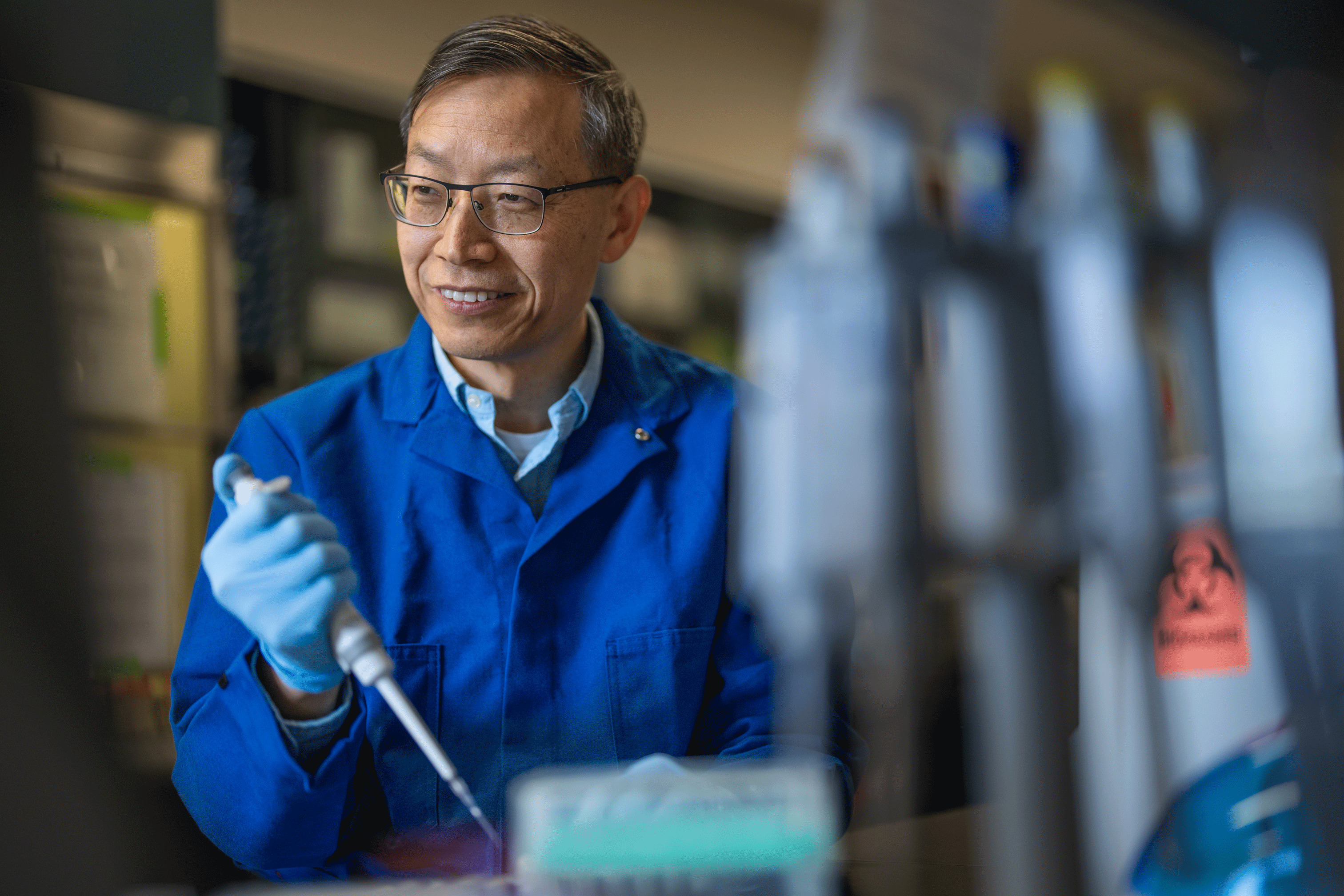 Huaijun Zhou, Ph.D. working in the lab.