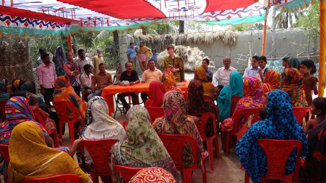 Hannah Waterhouse (standing middle center) introduces herself to a crowd of women gathered at a model farm to learn how to improve their homestead gardens in the Satkhira district of Bangladesh.
