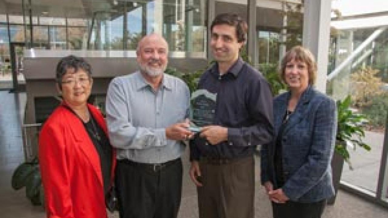 David Hosley (second from left) receives the inaugural Distinguished Service Award from Center for Regional Change director Jonathan London. Also present: Hosley’s wife gayle yamada (left), and Mary Delany, interim dean of the CA&ES. Photo John Stumbos