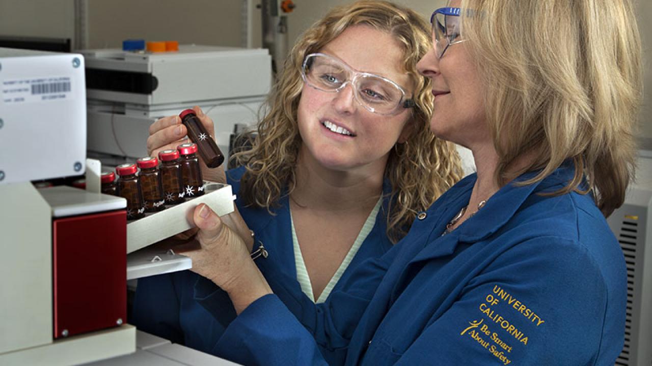 Adjunct professor Jenny Nelson and Professor Alyson Mitchell in the UC Davis Food Safety and Measurement Facility examine samples of almond volatiles. (Tony Novelozo | AXIOM)