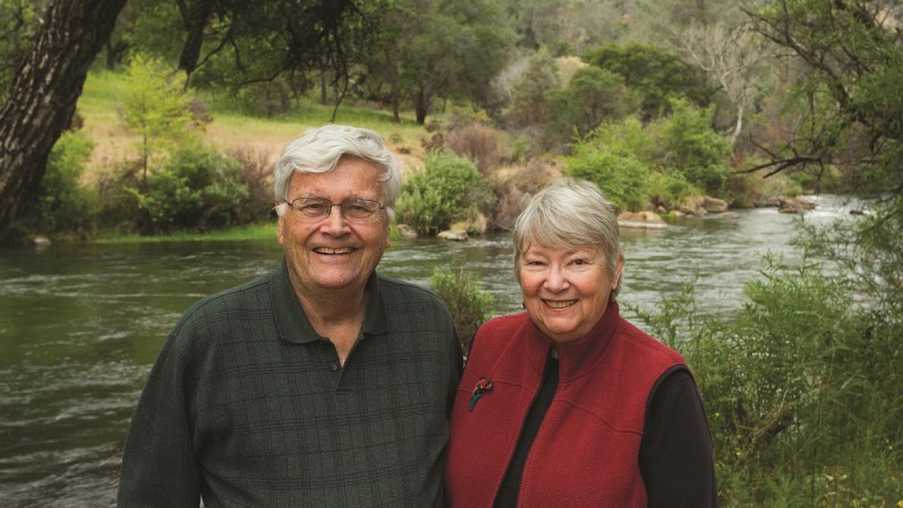 Tom and Ginny Cahill at Putah Creek and the land they donated to the university in the background.