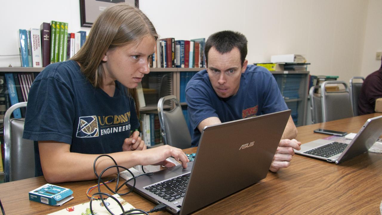 Kelley Drechsler (left), a biological systems engineering student, consults with Ryan Billing, a development engineer in the Department of Biological and Agricultural Engineering.