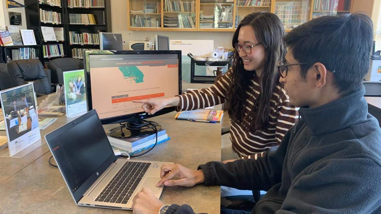 UC Davis graduate students Kamryn Kubose and Aniket Banginwar work on the General Plan Database Mapping tool they helped develop and troubleshoot. (Courtesy, UC Davis Center for Regional Change)