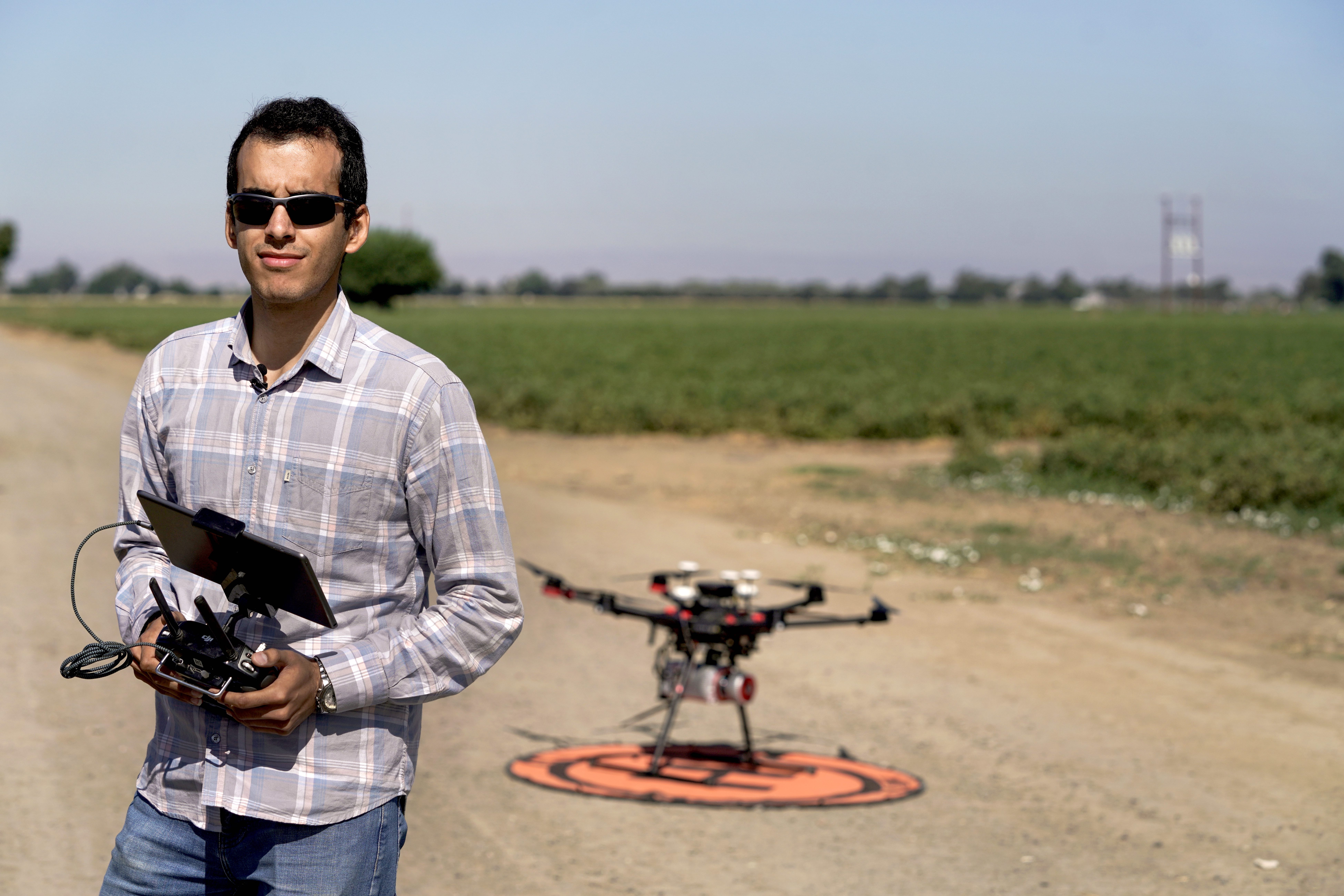 Ph.D. student Mohammadreza Narimani with a drone used to fly over a research field in Woodland as part of research into the parasitic weed Orobanche ramosa. (Karin Higgins/UC Davis)